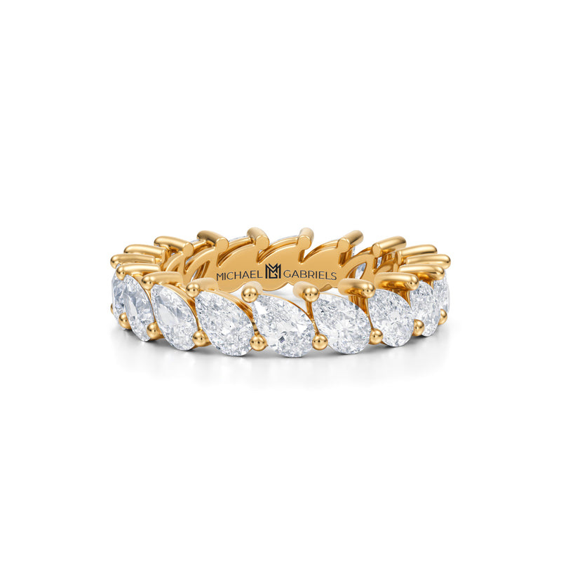 Small yellow gold eternity band with slanted pear lab-grown diamonds.